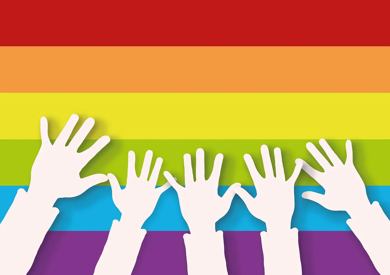 pride flag with hands over it