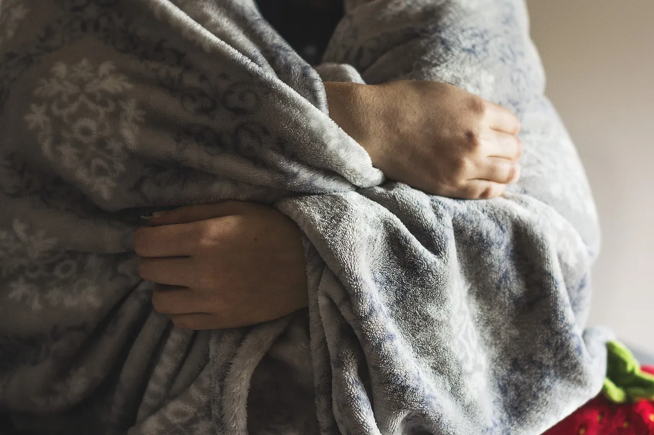 person wrapped in blanket chronic illness counselling